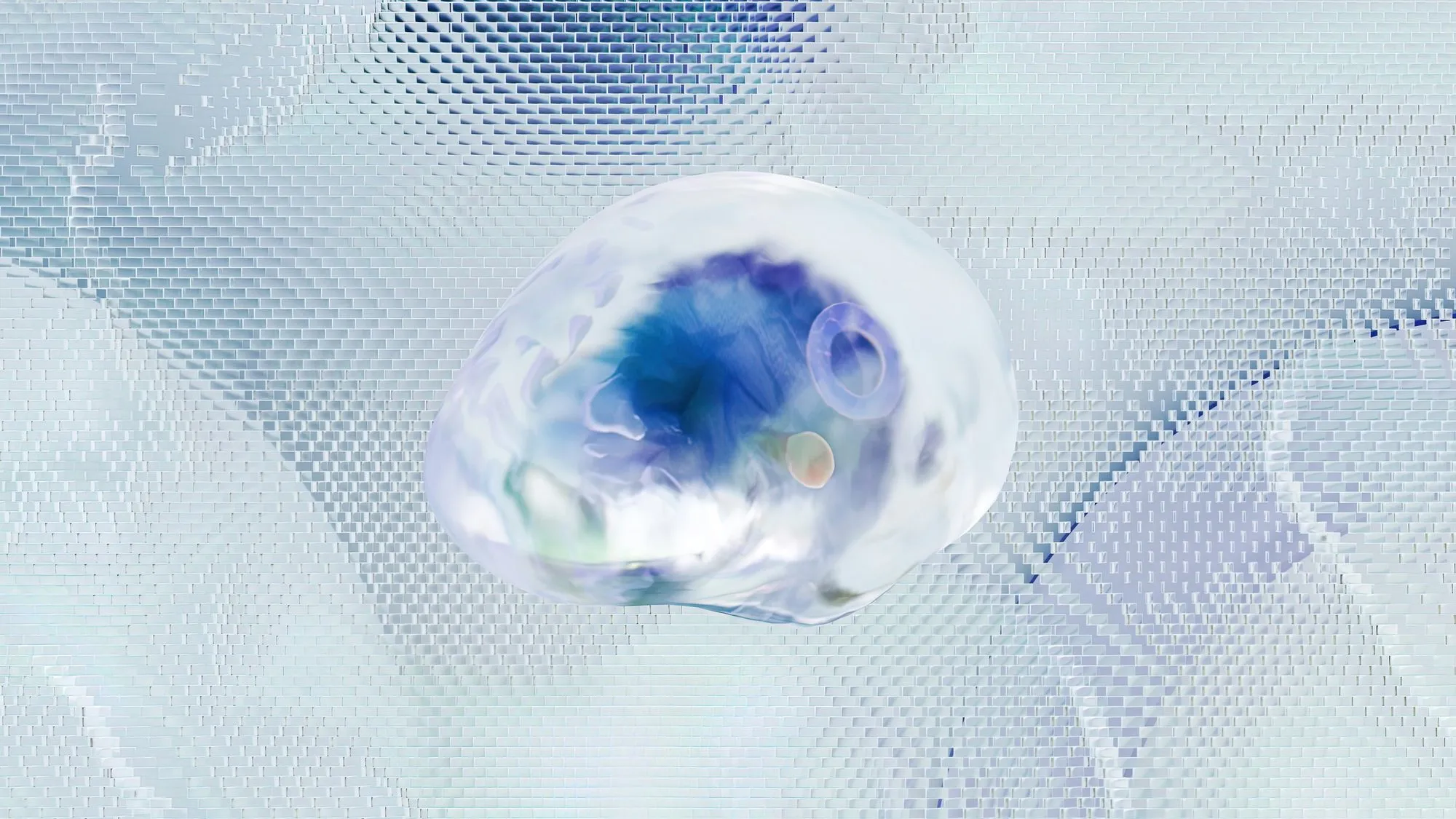 A clear glass droplet holding a swirl of blue, resting on a rippling surface of small pale tiles